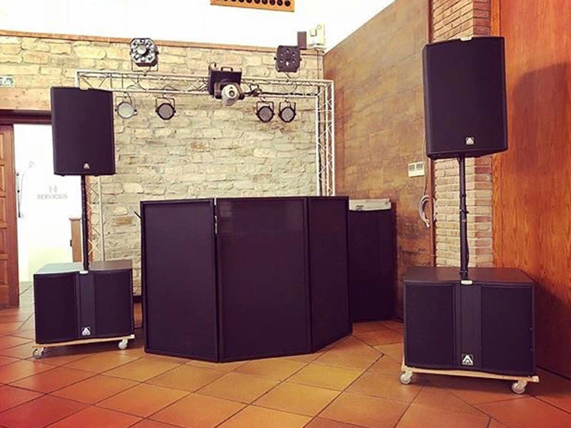DJ booth and PA speaker system with subwoofers and pole mounted top speakers