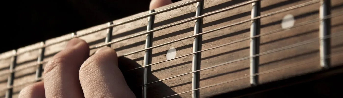 Which Guitar is Best to Learn On: Acoustic or Electric? Closeup of a guitar fretboard